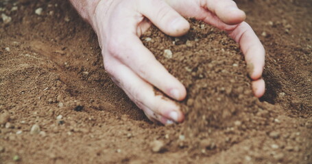 Farmer holding soil in hands. field.