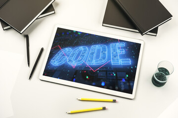Creative Code word hologram on modern digital tablet display, artificial intelligence and neural networks concept. Top view. 3D Rendering