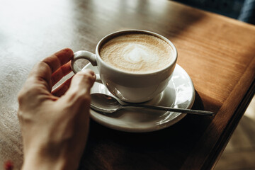 Cup of latte on the table top view. Breakfast at the cafe