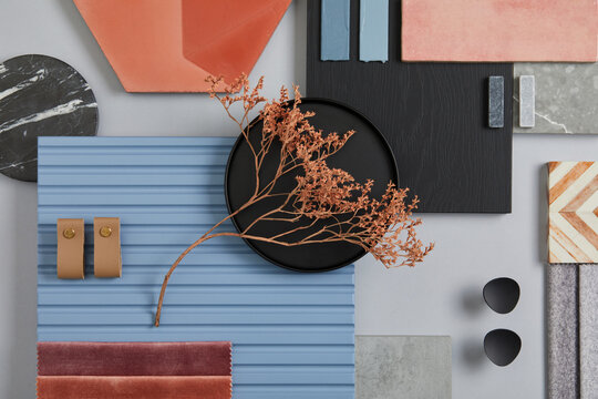 Creative flat lay composition of interior designer moodboard with textile and paint samples, blue lamella panels and tiles. Pink, black, blue and light grey color palette. Copy space. Template.