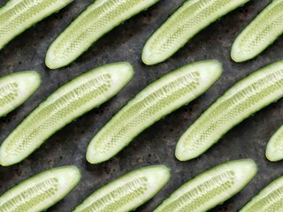 Fresh cucumber slices background. Spring vegetables pattern.
