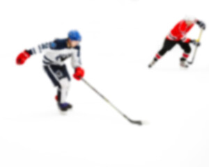 Active movement of hockey players on ice at speed in dynamics - out of focus hockey player on ice - blur hockey match on background