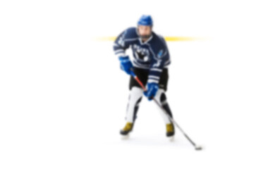 Active movement of hockey players on ice at speed in dynamics - out of focus hockey player on ice - blur hockey match on background