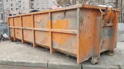 Metal trash can on the street on a sunny morning