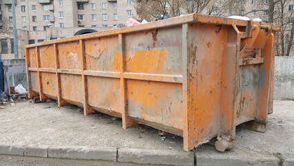 Fototapeta na wymiar Metal trash can on the street on a sunny morning