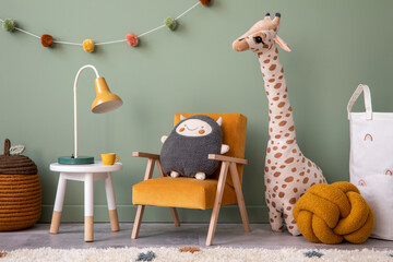 Creative composition of stylish and cozy child room interior design with green wall, plush toys,...