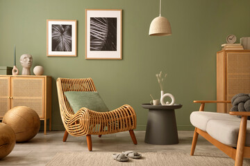 Creative living room interior composition with boho chair, mock up frames, commodes and personal accessories. Sage green wall. Template. Copy space.