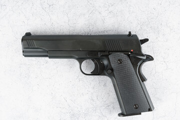 Black semi-automatic pistol on concrete