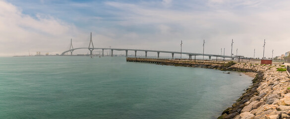 Fototapeta premium A view across a span hung bridge in the city of Cadiz on a spring day
