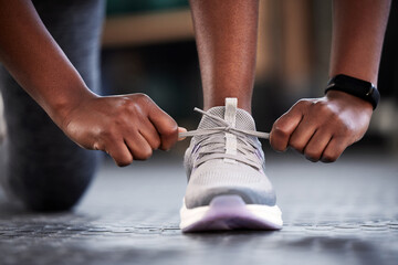 Take a small step every day and just keep going. Cropped shot of an unrecognizable woman tying her...