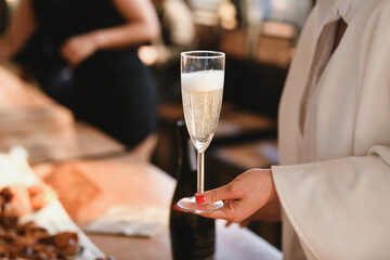 Bride holding a glass of champagne at a wedding
