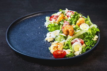 Fresh and tasty salad with grilled shrimps and fresh vegetables.