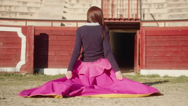 Back View Of Female Matador At Bullring Arena With Muleta On A Sunny Day. - static