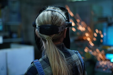 The girl is a welder. Back view