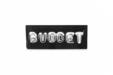 Black color banner that have embossed letter with word budget on white paper background