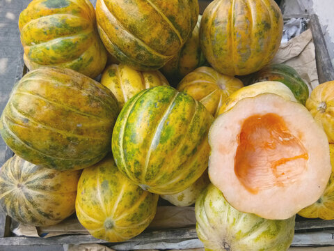 Stack of Indonesian cantaloupe variety with cut-half-fruit. Blewah or Garbis is an Indonesian Cantaloupe popular during Ramadhan as a dessert for breaking fast