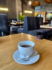 cup of coffee on wooden table in a cafe 