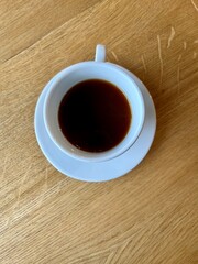 cup of coffee on wooden table in a cafe 