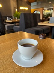 cup of coffee on wooden table in a cafe 
