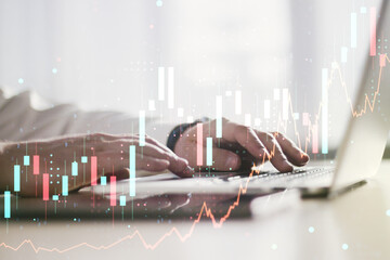 Multi exposure of abstract creative financial chart with hand typing on computer keyboard on...