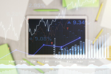 Abstract creative financial graph and modern digital tablet on background, top view, forex and investment concept. Multiexposure