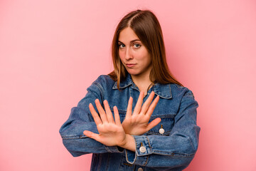 Young caucasian woman isolated on pink background doing a denial gesture