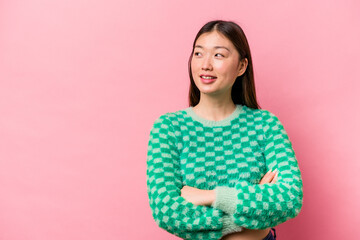 Fototapeta premium Young Chinese woman isolated on pink background smiling confident with crossed arms.