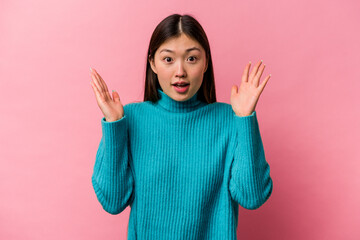 Young Chinese woman isolated on pink background having an idea, inspiration concept.