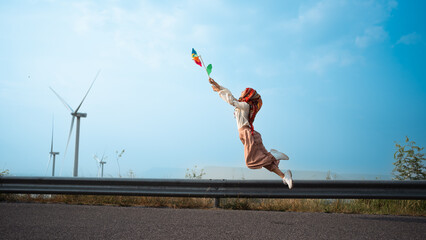 Muslim woman islam wearing hijab jumping floating happily holding colorful toy...