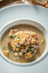 Seafood Soup on White Plate with Bread, Restaurant food