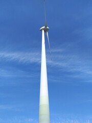 Fototapeta na wymiar Windmill for electric power production against blue sky.