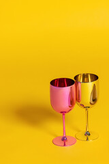 two glasses of champagne on a yellow background