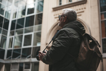 Senior amateur photographer takes photos at leisure. Hobby of a pensioner.