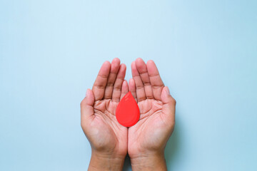 Hands holding blood drop, world blood donor day concept