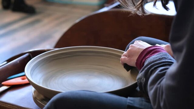 Pottery polishing process with 2 hands in the final step. Before entering the kiln. Slow motion video