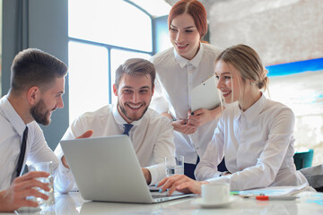 Group of business partners discussing ideas and planning work in office.