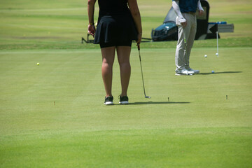 A back shot of an active woman playing golf in Mexico