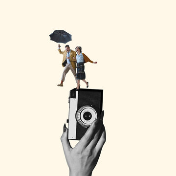 Contemporary art collage. Young loving couple with umbrella running on retro camera device isolated over light yellow background