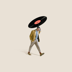 Contemporary art collage. Stylish thoughtul man walking under retro vinyl record isolated over...