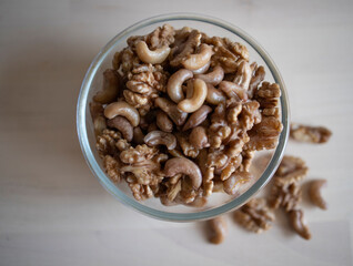 Roasted walnut and cashew, lie in a plate on the table. Protein, useful nuts. Nut Mix
