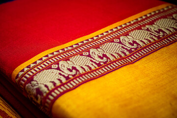 The distinctive feature of Ilkal saris is the use of a form of embroidery called Kasuti. The Kasuti designs reflect traditional patterns like palanquins, elephants & lotuses which are embroidered.