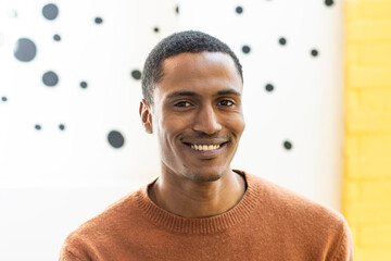 Portrait of happy middle eastern man looking at camera indoor - Handsome moroccan guy smiling at...