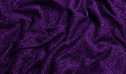 Smooth shiny fabric texture with folds and wawes. Close up silk background