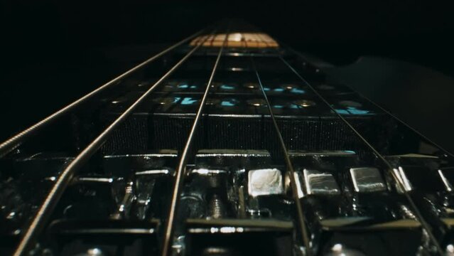 Six-string electric guitar bridge and saddle.