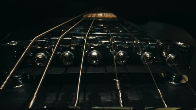 Six-string electric guitar bridge and saddle.