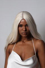 Portrait of attractive Black young woman with long blond hair. Vertical.
