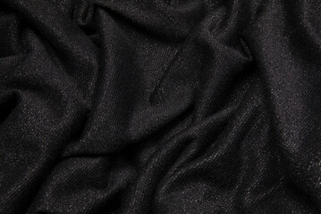 Smooth shiny fabric texture with folds and wawes. Close up silk background