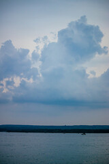 large clouds over fishing boats