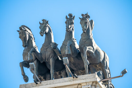 Statues of chariots with four horses on the rooftops of the Gran Vía in the city of Madrid during a sunny day