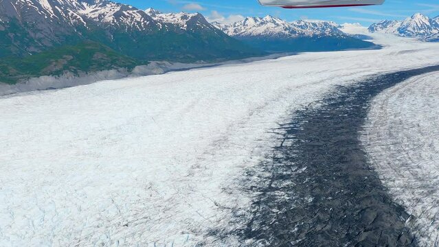 Flying over the Knik glacier with mountains in the distance east of Palmer Alaska.